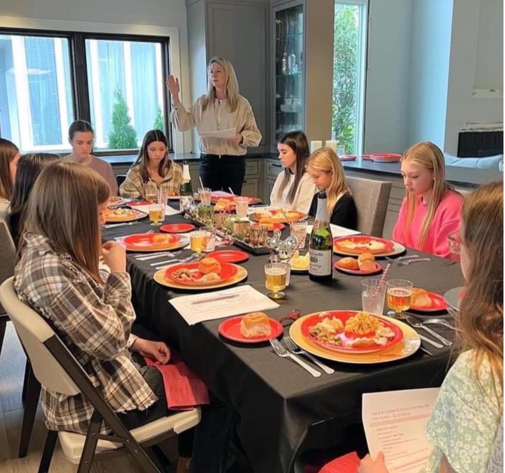 Instructor teaching dining etiquette to a group of teens