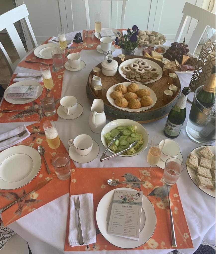 Brunch table with champagne, pastries, and floral place settings