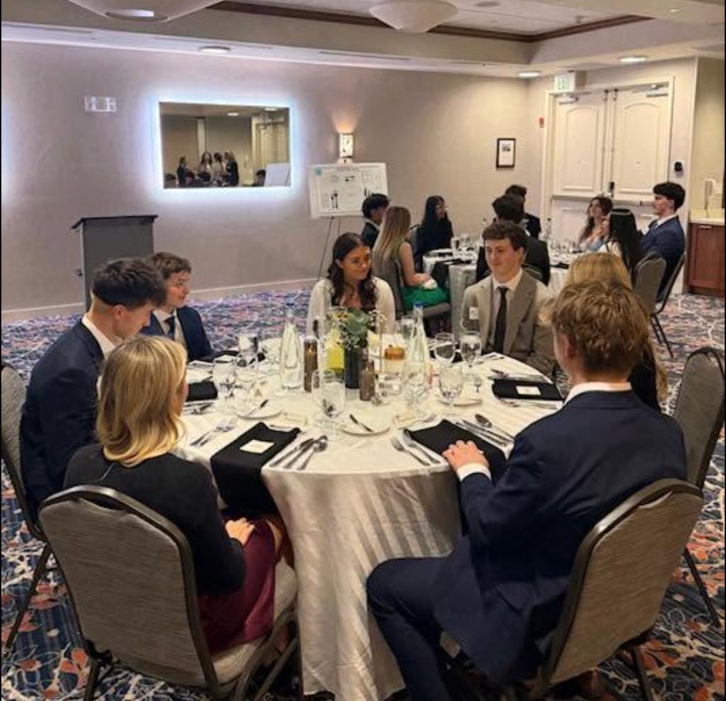 Teens practicing formal dining etiquette at a banquet event