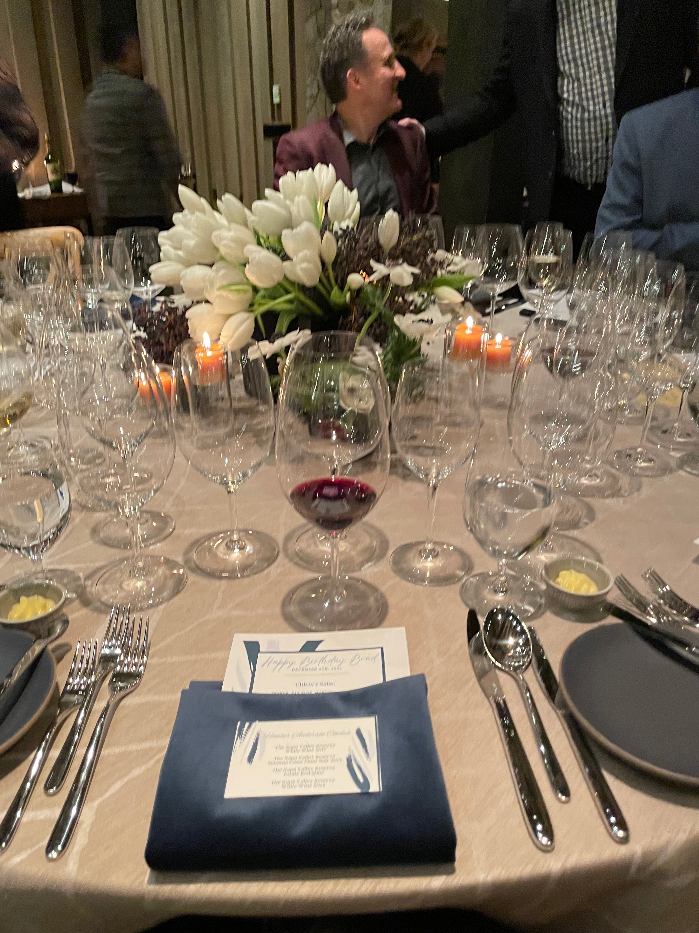 Wine tasting table with tulip centerpiece and place settings